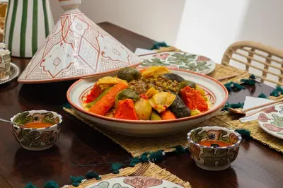a table with a bowl of food on a table at Riad Sharif in Marrakech