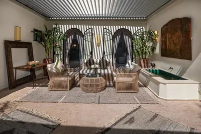 a living room with a couch and chairs and a tub at Dar Mo'Da in Marrakech