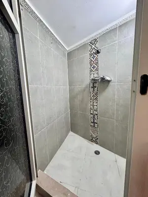 a bathroom with a shower with a glass door at Studio mezzanine cosy près de Jemaa el-Fna in Marrakech