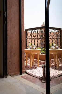 two tables with food on them sitting on a balcony at Excellent apartment plus hot tub in Marrakech