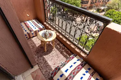 a balcony with a table and a bowl on it at Excellent apartment plus hot tub in Marrakech