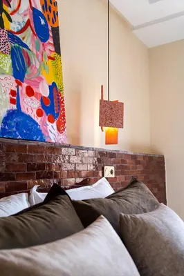 a bedroom with a bed and a painting on the wall at Excellent apartment plus hot tub in Marrakech