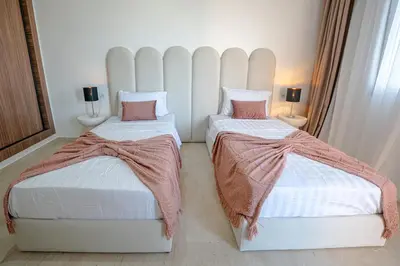 two beds sitting next to each other in a room at œil de la vallée in Marrakech