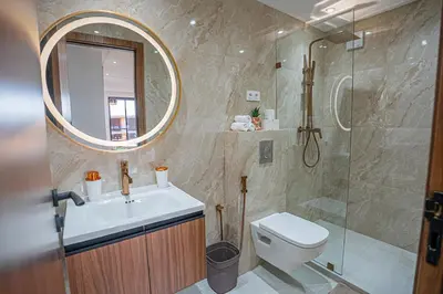 a bathroom with a toilet and a sink and a shower at œil de la vallée in Marrakech