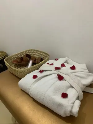 a white towel with hearts on it next to a basket of cookies at Asaithic filipina healing hands in Marrakech