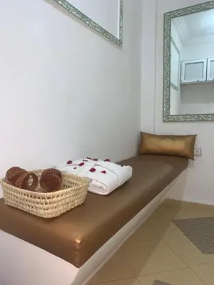 a bed with a mirror and a basket on it at Asaithic filipina healing hands in Marrakech