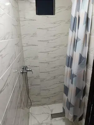 a bathroom with a shower with a shower curtain at Riad kech residence al Qarya syahiya Marrakech in Marrakech