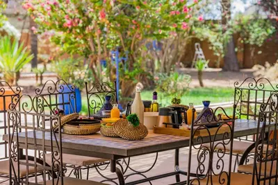 a table with baskets of food on it with chairs at Villa Provence - Pool and Private Garden in Marrakech
