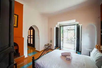 a bedroom with a bed with a hat on it at Villa Provence - Pool and Private Garden in Marrakech