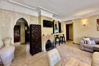 a living room with a couch and a fireplace at Al Qantara with Terrace and Pool in Marrakech