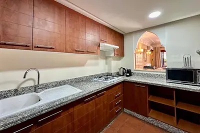 a kitchen with a sink and a microwave at Al Qantara with Terrace and Pool in Marrakech