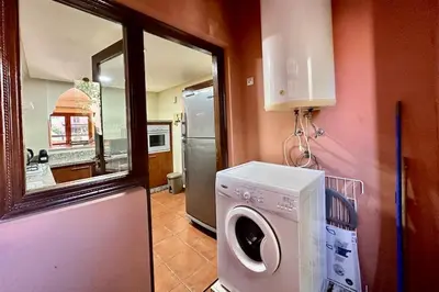a kitchen with a washing machine and a window at Al Qantara with Terrace and Pool in Marrakech