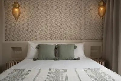 a bedroom with a large white bed with two pillows at Riad Tassili Vert in Marrakech