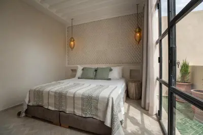a bedroom with a bed and a balcony at Riad Tassili Vert in Marrakech