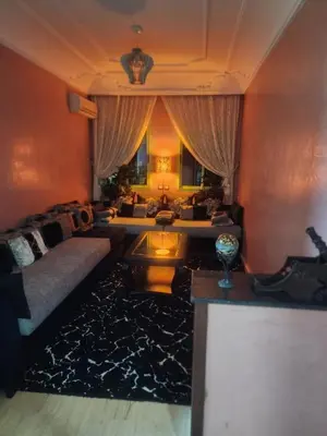 a living room with a couch and a table at Appartement in Marrakech