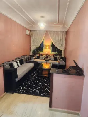 a living room with a couch and a table at Appartement in Marrakech