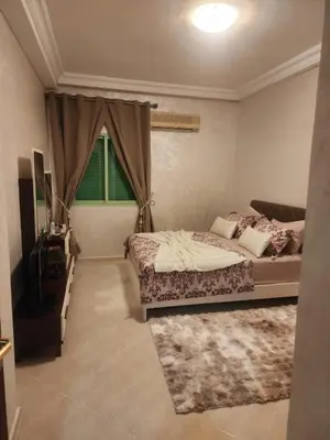 a bedroom with a large bed and a window at Appartement in Marrakech