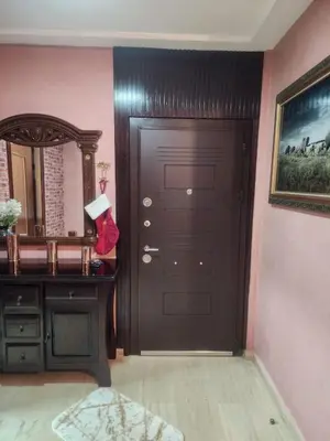 a room with a black door and a mirror at Appartement in Marrakech