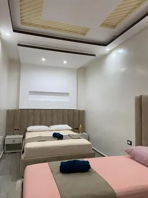 a bedroom with four beds in a room with a ceiling at KSYI IMMO 6 Marrakech Aéroport in Marrakech
