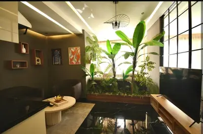 a bathroom with a pond with plants in it at Luxurious apartment with private jacuzzi in Marrakech