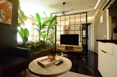 a living room with a couch and a tv and a table at Luxurious apartment with private jacuzzi in Marrakech