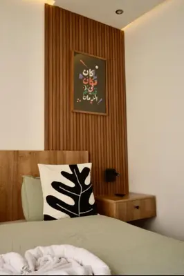 a bedroom with a bed and a picture on the wall at Luxurious apartment with private jacuzzi in Marrakech