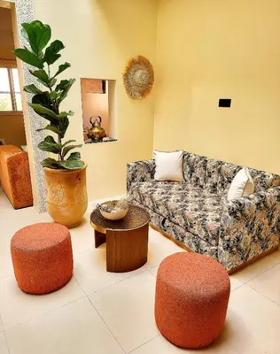 a living room with a couch and two ottomans at Riad Duplex de charme 2 chambres in Marrakech