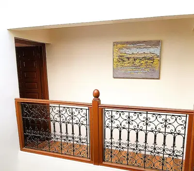 a staircase with a fence and a picture on the wall at Riad Duplex de charme 2 chambres in Marrakech