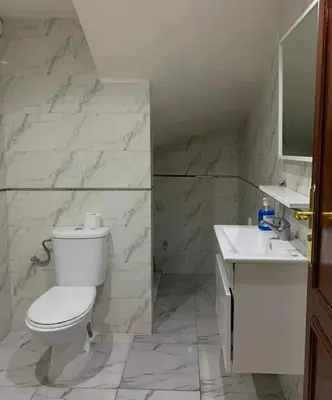 a bathroom with a white toilet and a sink at شقة قريبة جدا من المطار وقريبة للمآثر التاريخية و المدينة الجديدة كليز in Marrakech