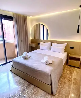a bedroom with a large bed with towels on it at Élégance & confort au centre ville de Marrakech in Marrakech