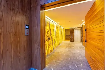 a hallway with wooden walls and a yellow painting on the wall at Élégance & confort au centre ville de Marrakech in Marrakech