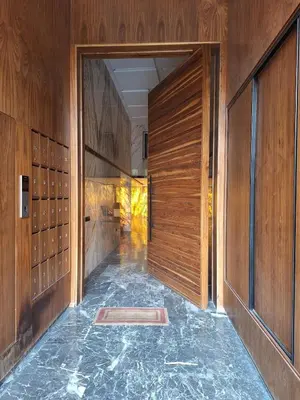 an empty hallway with wooden walls and a door at Élégance & confort au centre ville de Marrakech in Marrakech