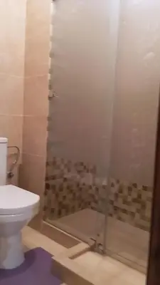 a bathroom with a shower with a toilet at Charmant appartement au coeur de Guéliz à côté de train in Marrakech