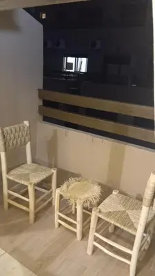 a room with two chairs and a table and a window at Charmant appartement au coeur de Guéliz à côté de train in Marrakech
