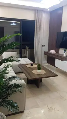 a living room with a couch and a coffee table at Charmant appartement au coeur de Guéliz à côté de train in Marrakech
