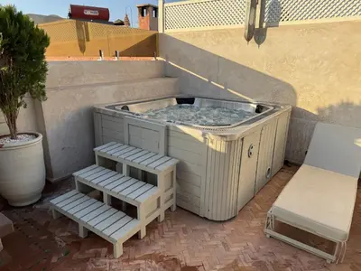 a hot tub with steps next to a building at Taj Riad Zitoune in Marrakech