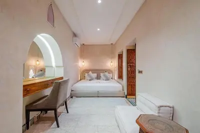 a hotel room with a bed and a desk and a desk at Taj Riad Zitoune in Marrakech