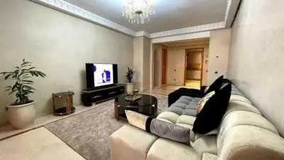 a living room with a couch and a television at Chic Plaza City Center in Marrakech