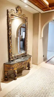 a mirror sitting on top of a table in a room at Chic Plaza City Center in Marrakech