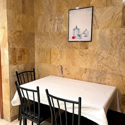 a table with two chairs and a picture on the wall at Chic Plaza City Center in Marrakech