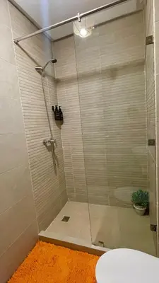 a shower with a glass door in a bathroom at Cozy apartment with pool Downtown Marrakech in Marrakech