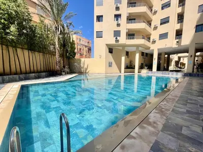 a swimming pool in front of a building at Burj Malak Comfort and Pool in Marrakech