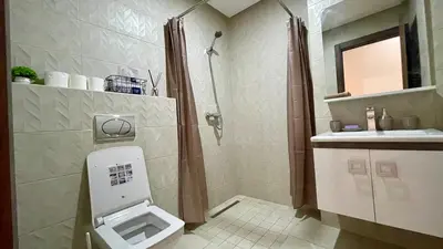 a bathroom with a shower and a toilet and a sink at Burj Malak Comfort and Pool in Marrakech