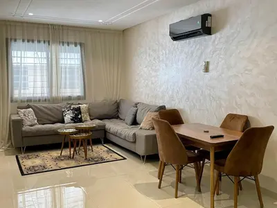 a living room with a couch and a table at Burj Malak Comfort and Pool in Marrakech