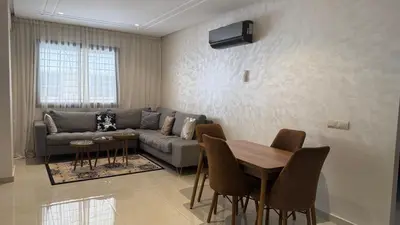 a living room with a couch and a table at Burj Malak Comfort and Pool in Marrakech