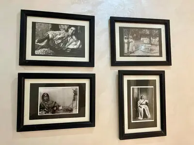 a group of framed pictures hanging on a wall at Burj Malak Comfort and Pool in Marrakech