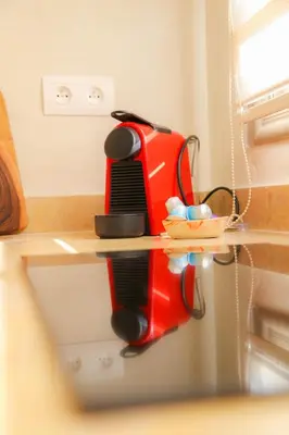 a red toaster sitting on top of a kitchen counter at Stylish YSL Street 2-BDR, parking, hi speed wifi in Marrakech