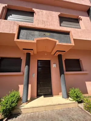 a building with a black door and pillars at Appartement moderne 2 chambres proche Gueliz in Marrakech