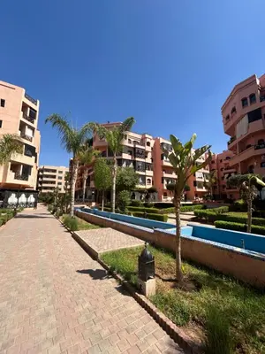 a brick road with palm trees and buildings at Appartement moderne 2 chambres proche Gueliz in Marrakech