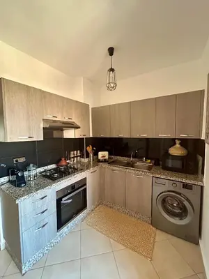 a kitchen with a sink and a washing machine at Appartement moderne 2 chambres proche Gueliz in Marrakech